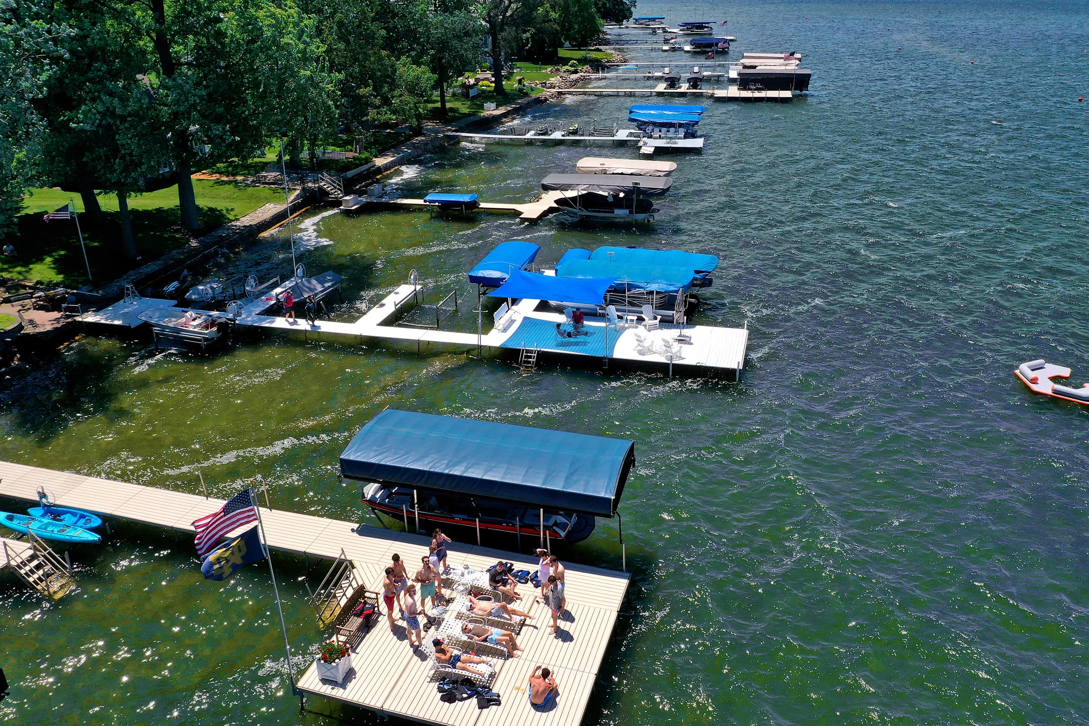 A real DockShade covering the seating area at the end of a dock while the lake stays open around it