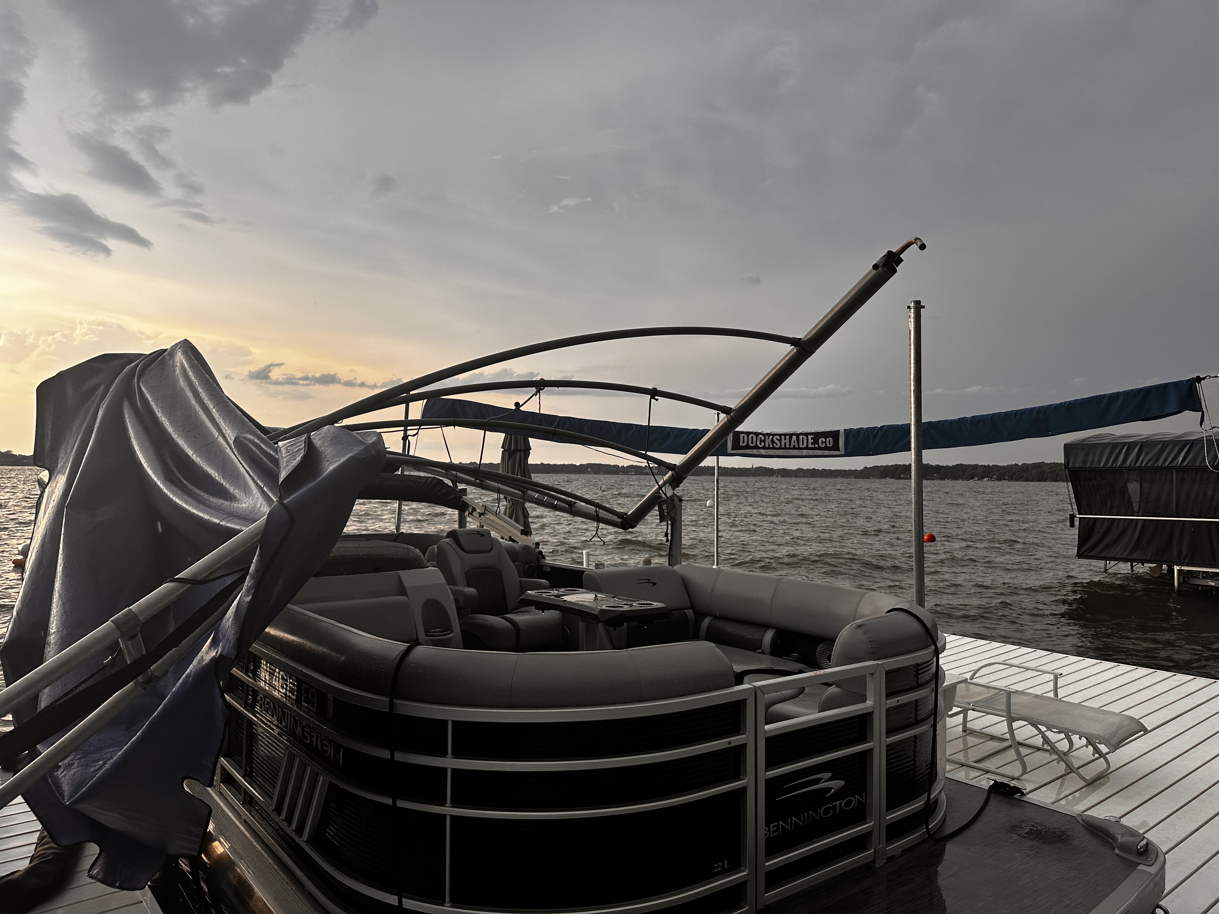 A furled DockShade beside a pontoon after a summer storm at sunset
