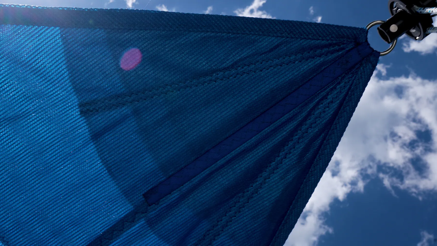 Sunlight passing through the blue mesh fabric of a real DockShade